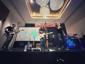 four musicians rocking out on stage